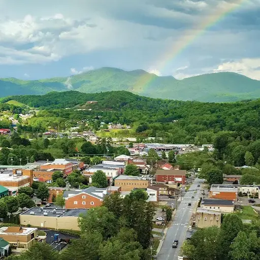 Aerial view of Franklin, North Carolina near Sanctuary Village with mountains and a rainbow