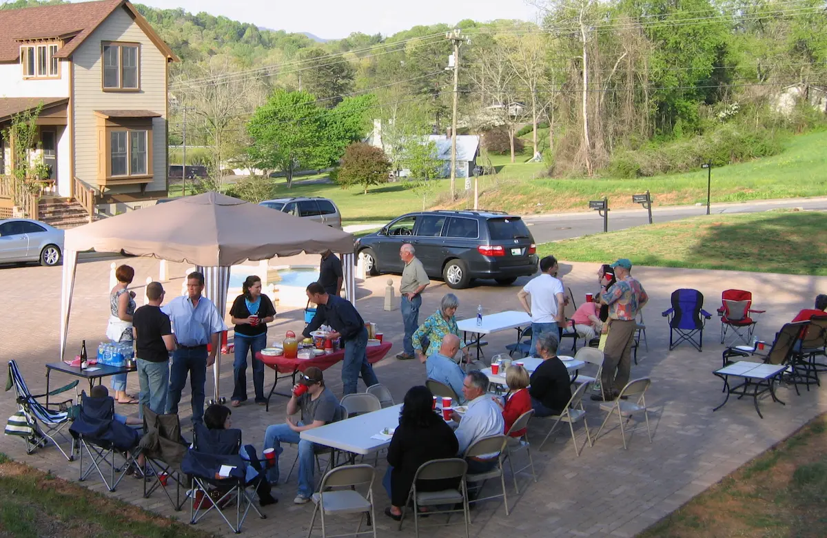 Friends gathered on plaza at Sanctuary Village for a potluck dinner