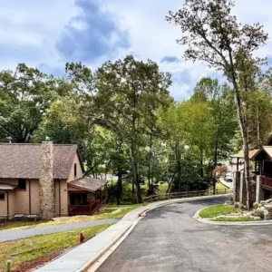 Homes at the lower end of Village Circle East in Sanctuary Village with front porches and wooded surroundings
