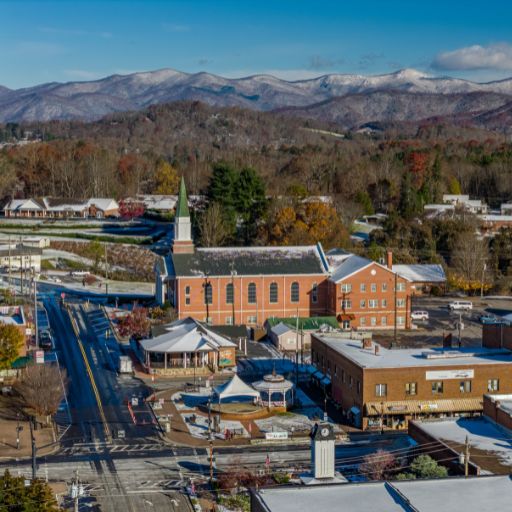 Aerial view of downtown Franklin, NC with buildings on Main Street and mountains in the background