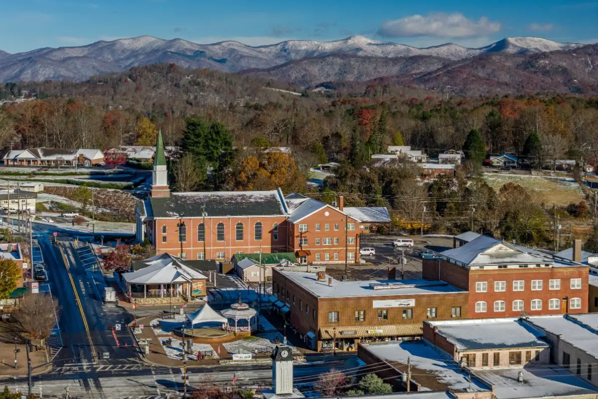 Aerial view of downtown Franklin, NC with buildings on Main Street and mountains in the background