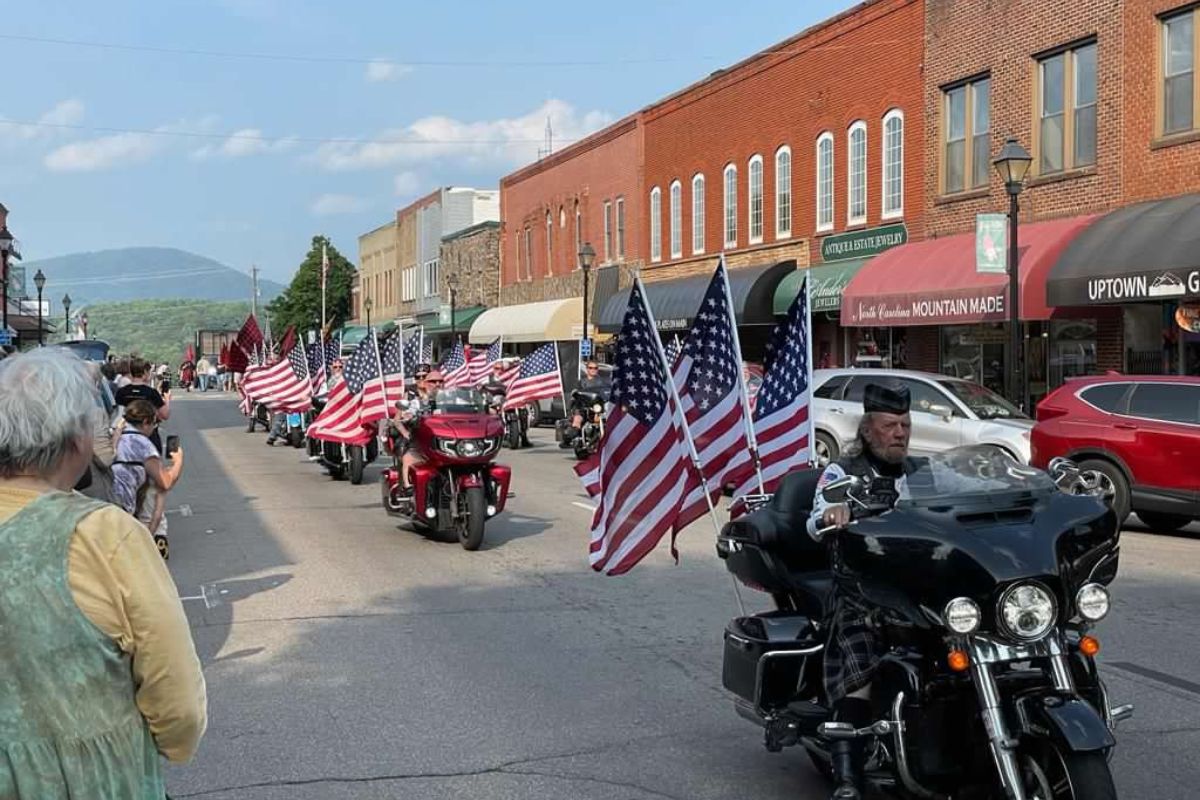 Parade downtown Franklin, NC showing motorcycles and people on the sidewalk