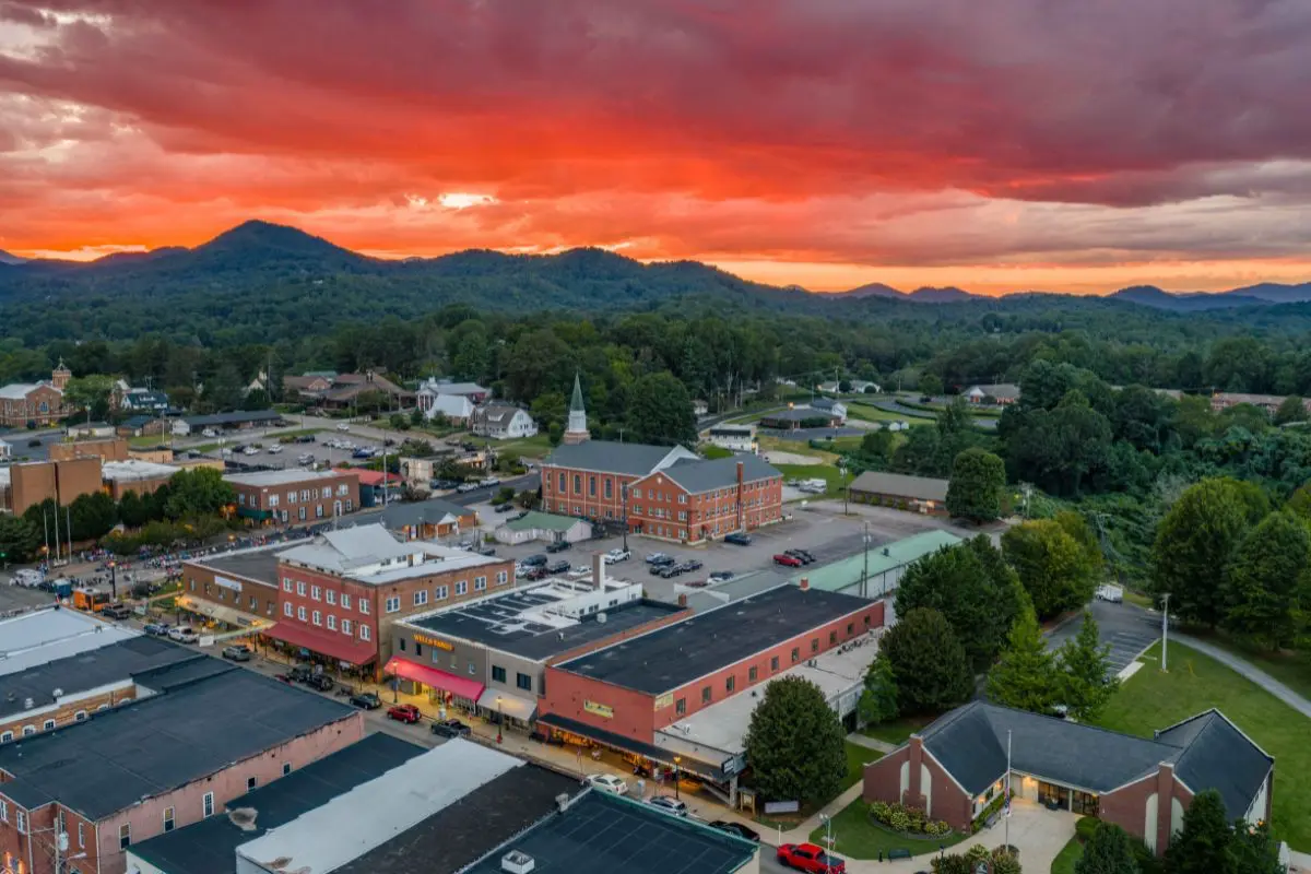 Aerial view of Franklin NC showing buildings on Main Street and sunset