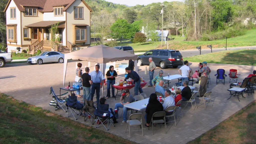 People gathering for an outdoor meal in a walkable community that reflects good urbanism and social connection