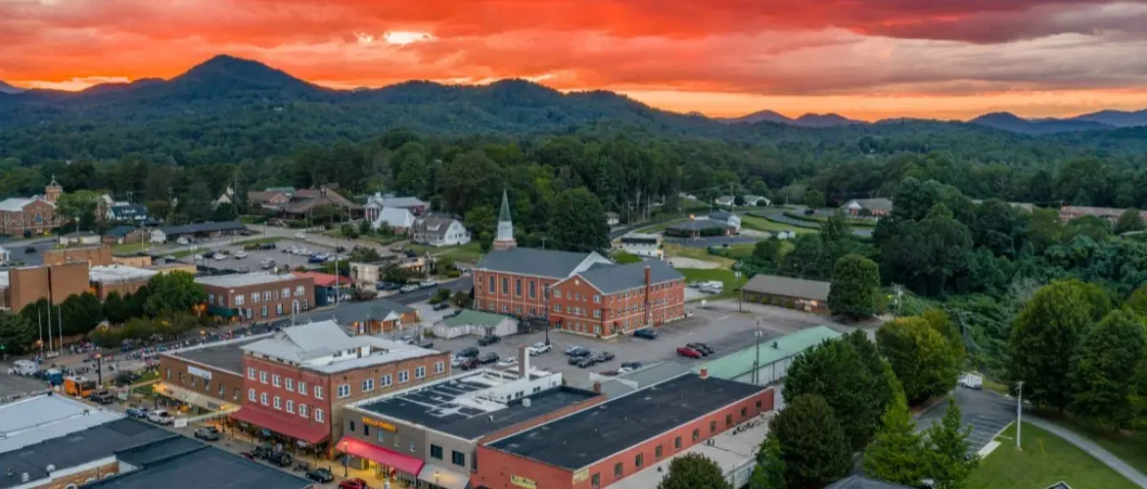 Aerial view of Franklin NC showing buildings on Main Street and sunset