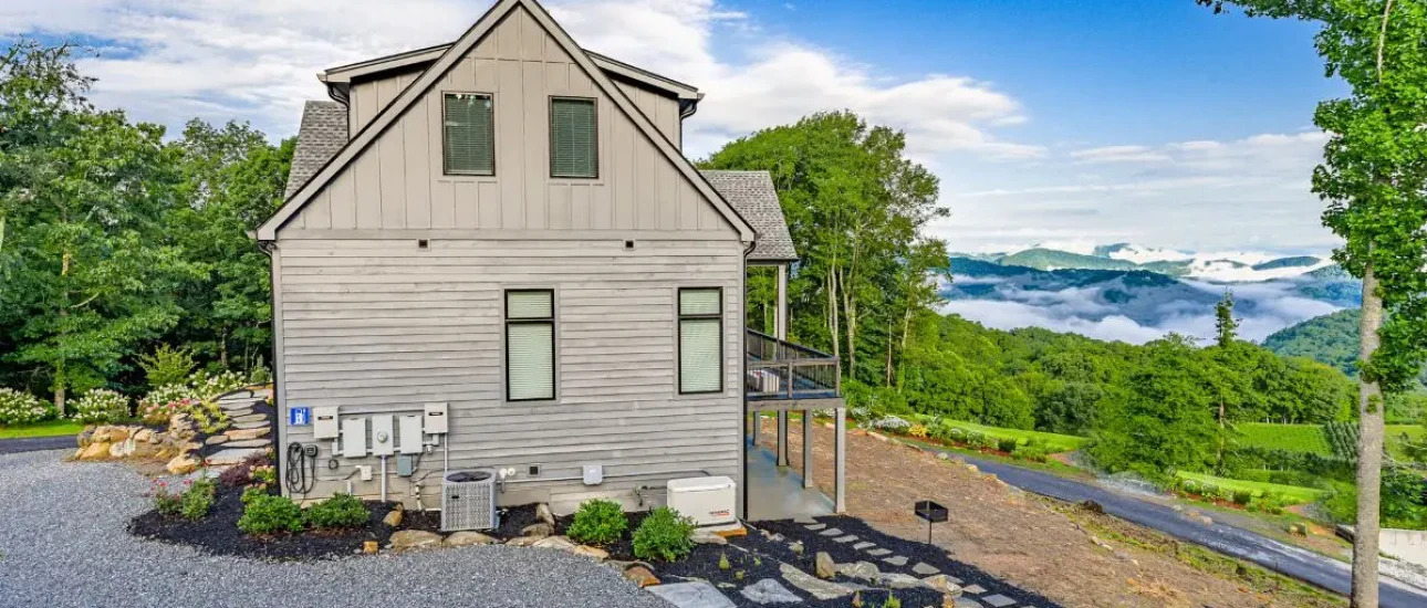 Living in Highlands or Cashiers NC. Side view of home in Highlands in showing driveway and long range views