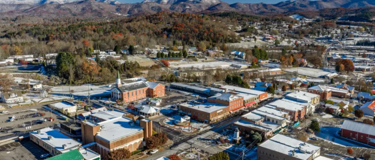 Aerial view of downtown Franklin showing buildings on Main Street and the mountains in the background
